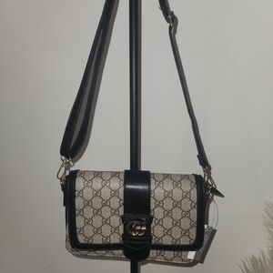 Elegant Black and Cream Crossbody Bag with Monogram Print